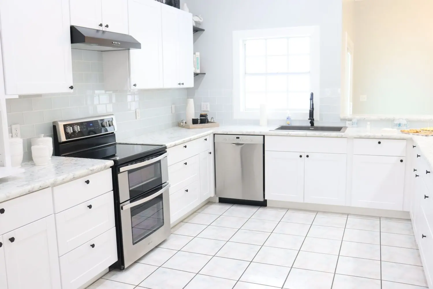 Bright, clean white kitchen with stainless appliances